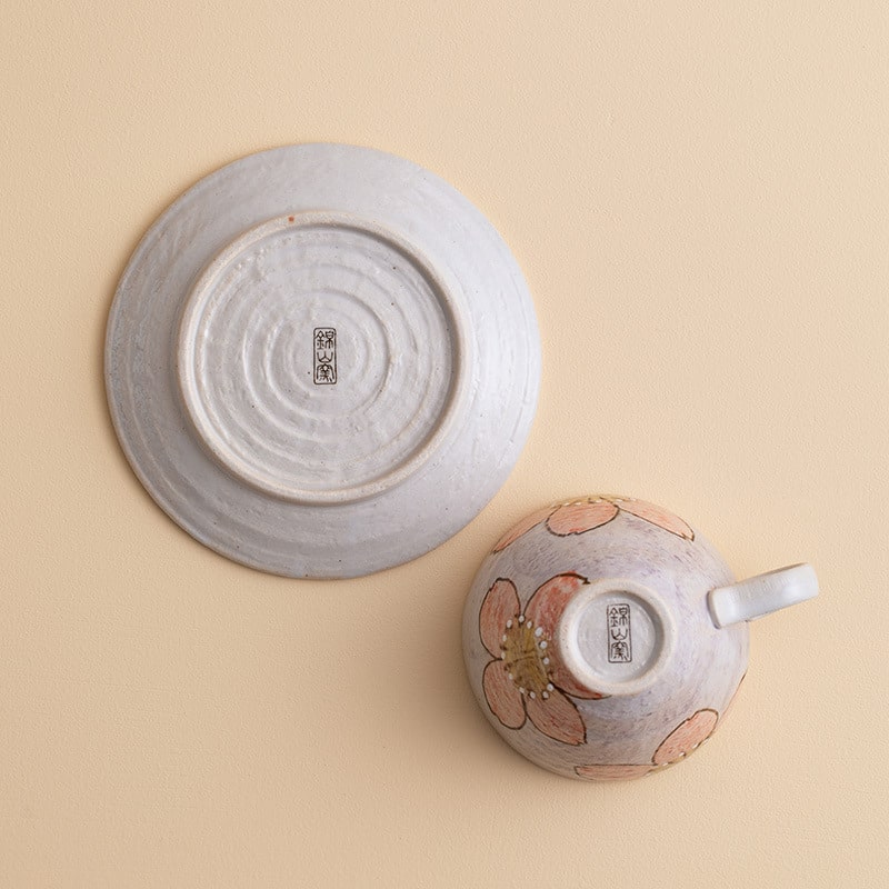 Elegant hand-painted ceramic cup with pastel sakura flowers.