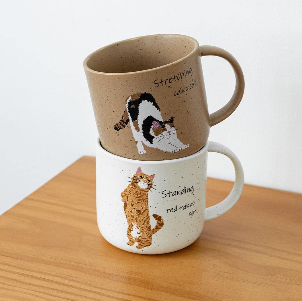 Pair of handcrafted mugs with charming cat-inspired illustrations.