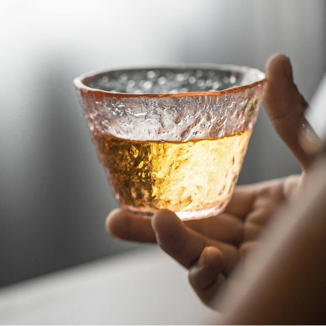 Textured pink glass cup for hot and cold drinks.