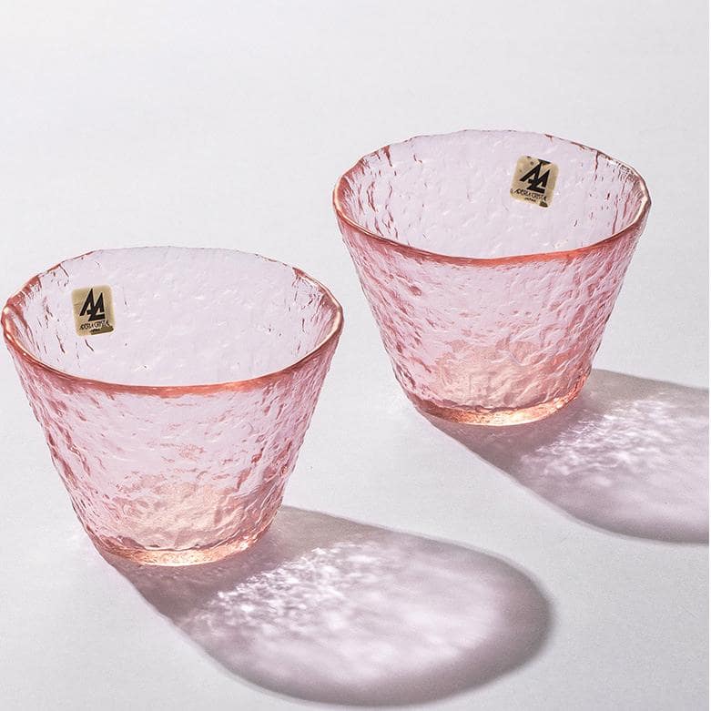 Artistic pink glassware reflecting natural light beautifully.