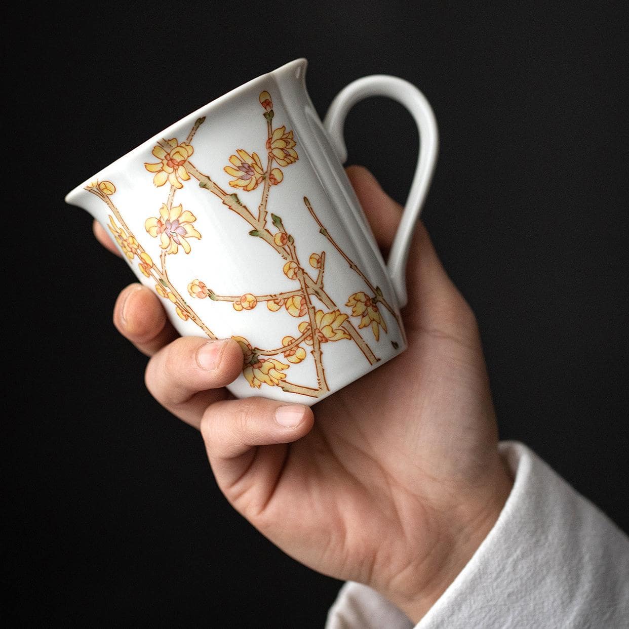 Artistic collection of floral ceramic mugs on display