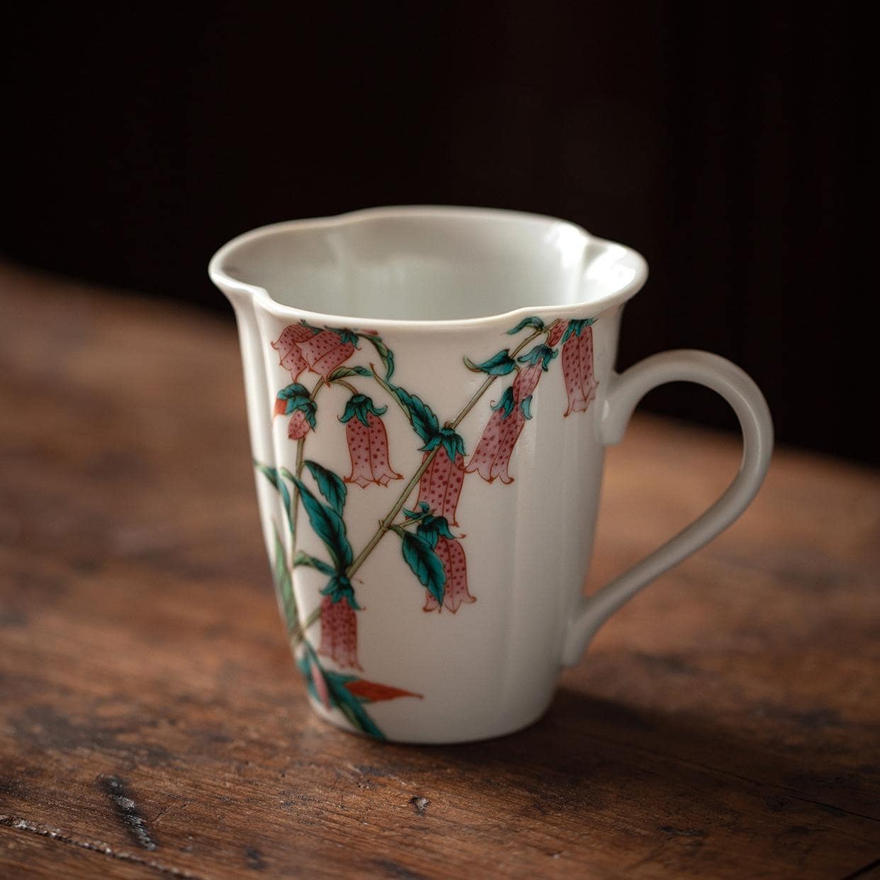 Handcrafted ceramic mug with golden floral patterns