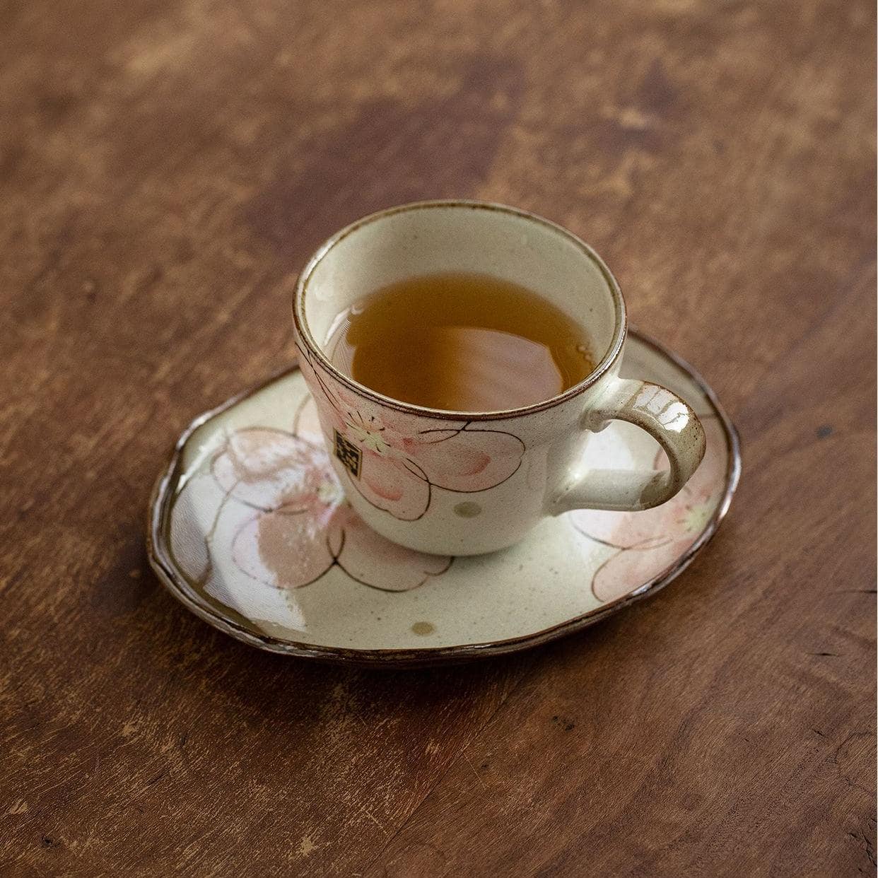 Artistic ceramic tea cup set featuring a delicate floral pattern.