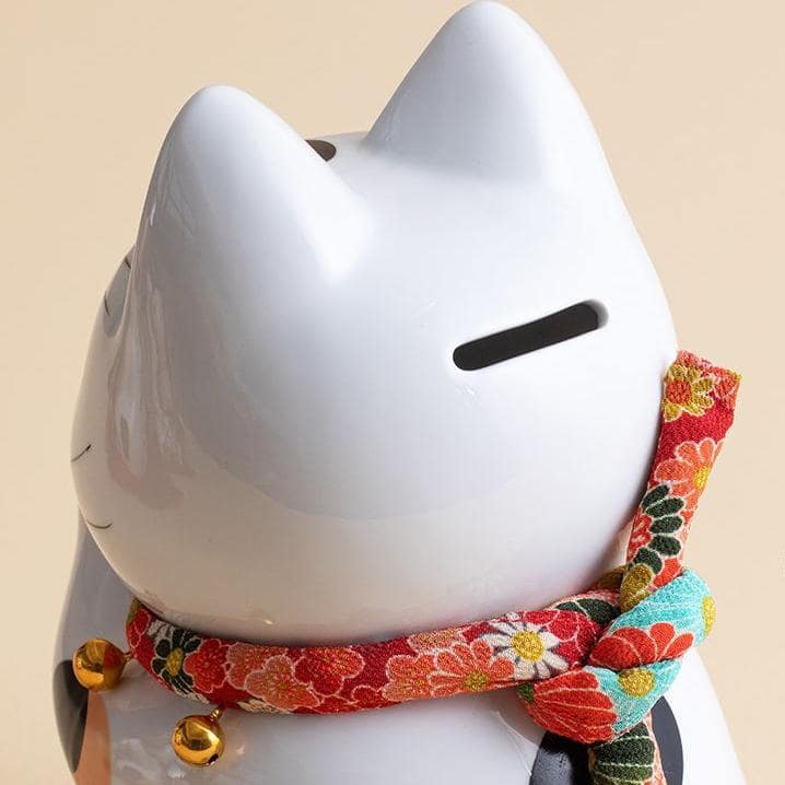 Handcrafted ceramic lucky cats in vibrant traditional designs.