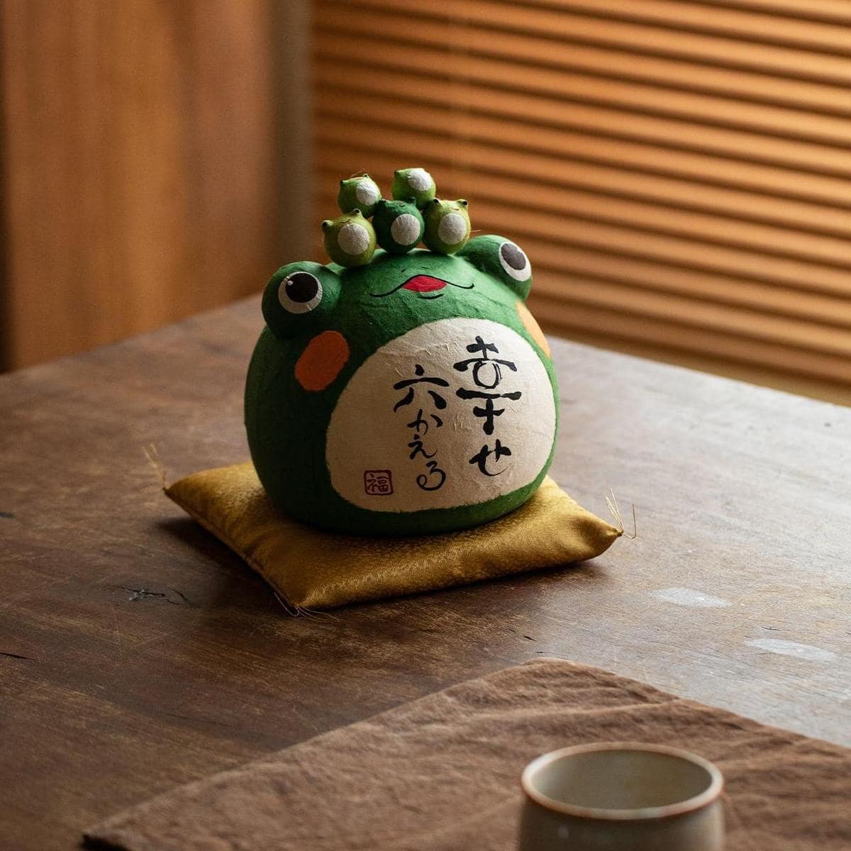 Adorable travel peace frog figurine with hand-painted details.