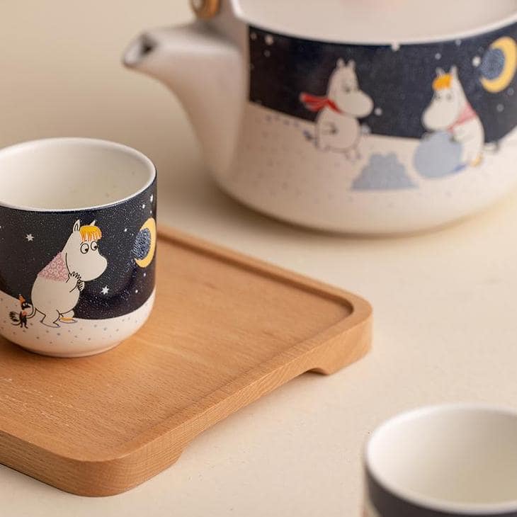 Moomin tea set in soft yellow tones, perfect for cozy tea moments.