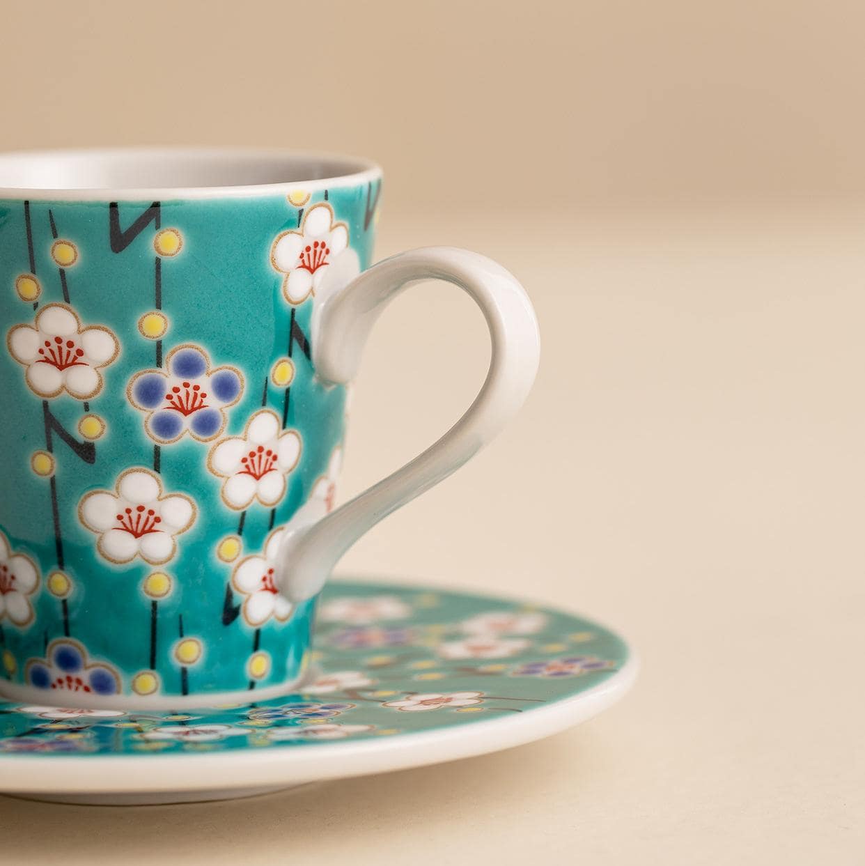 Four espresso cups with distinct vibrant floral designs