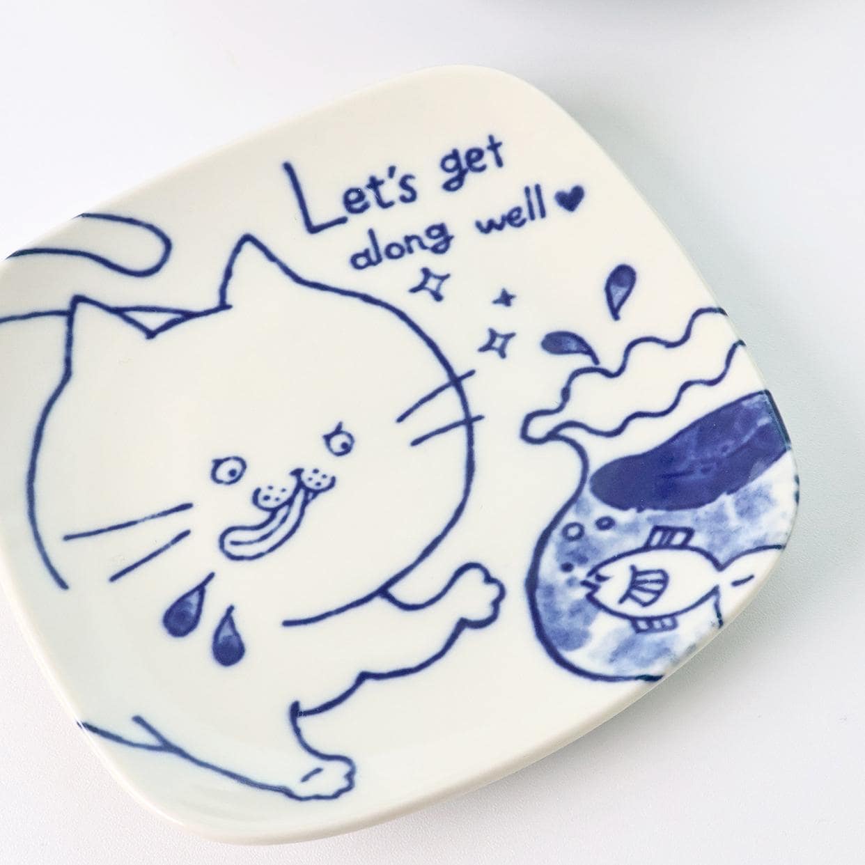 Set of Japanese cat-themed ceramic plates and small bowls