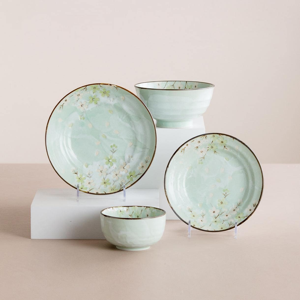 Full tableware set with cherry blossom design ceramic plates.