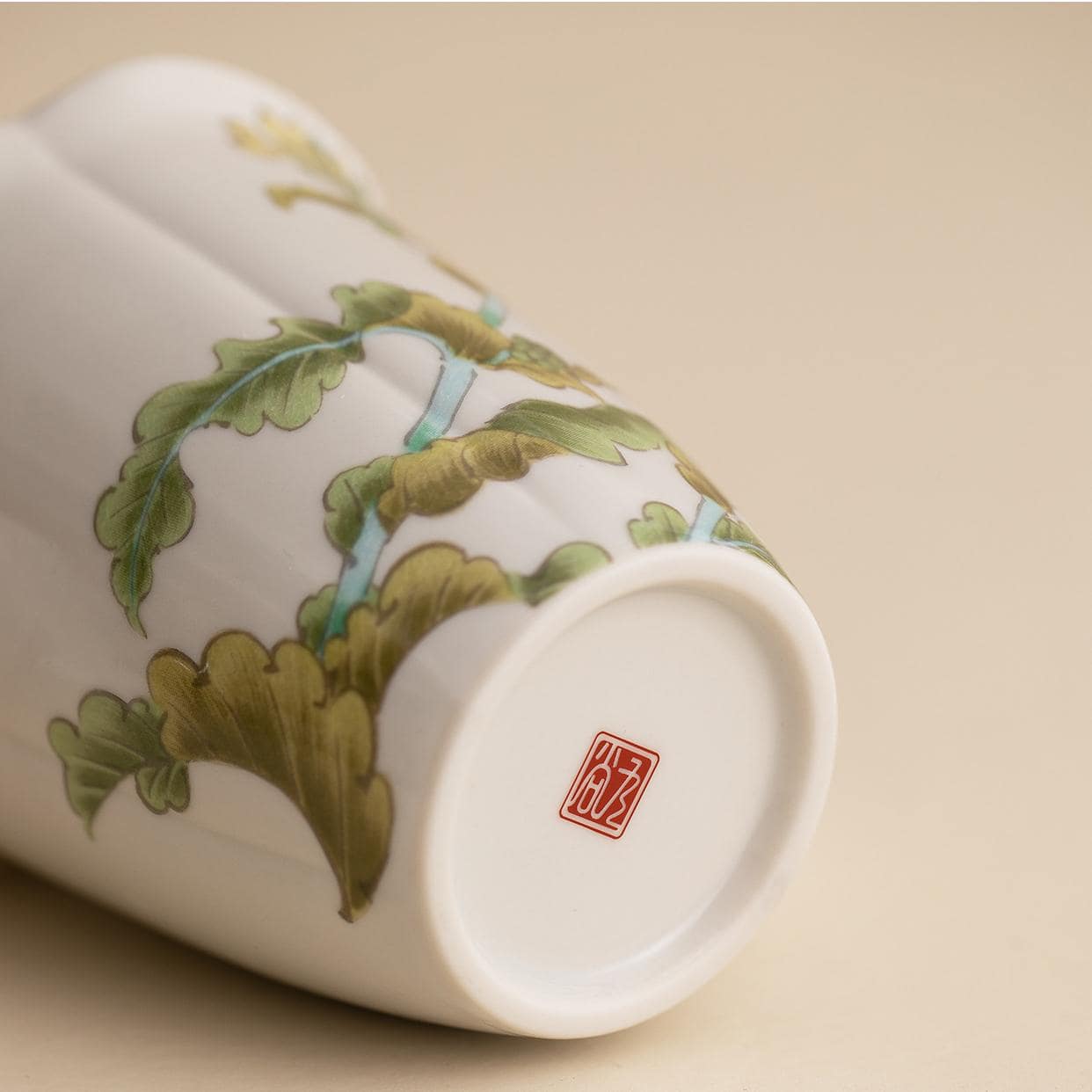 Handcrafted ceramic mug with golden floral patterns