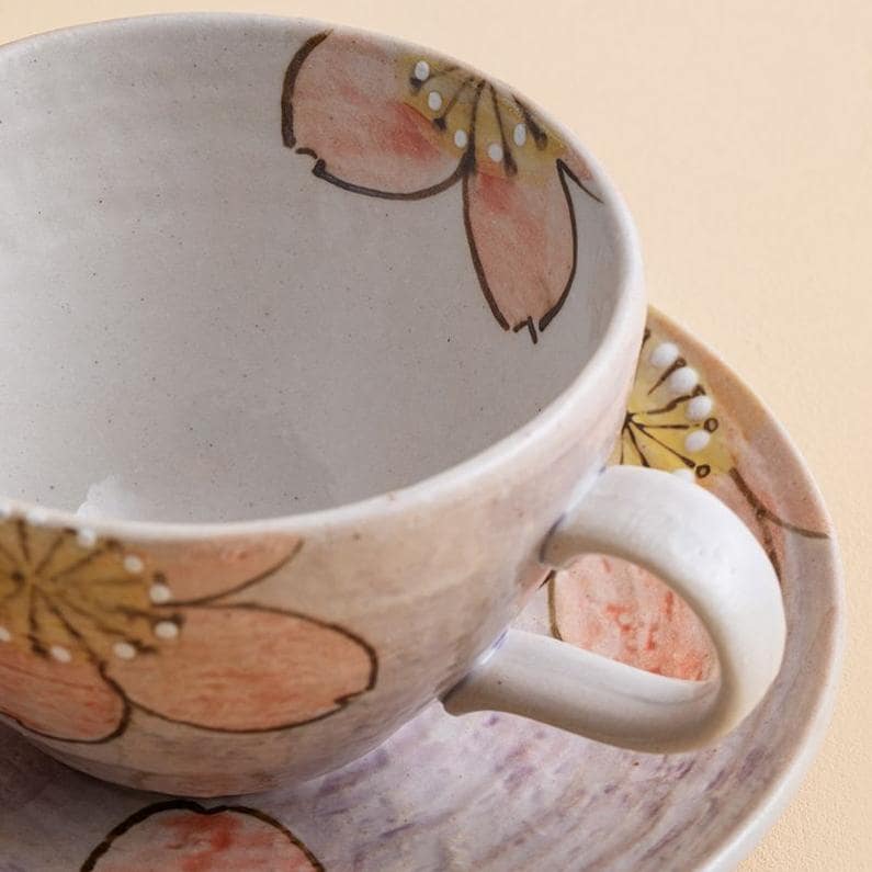 Artistic ceramic tea cup set featuring a delicate floral pattern.