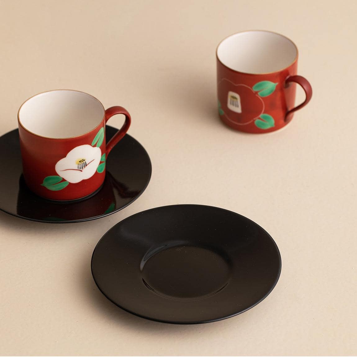 Handcrafted Mino ware coffee cups with intricate red designs.