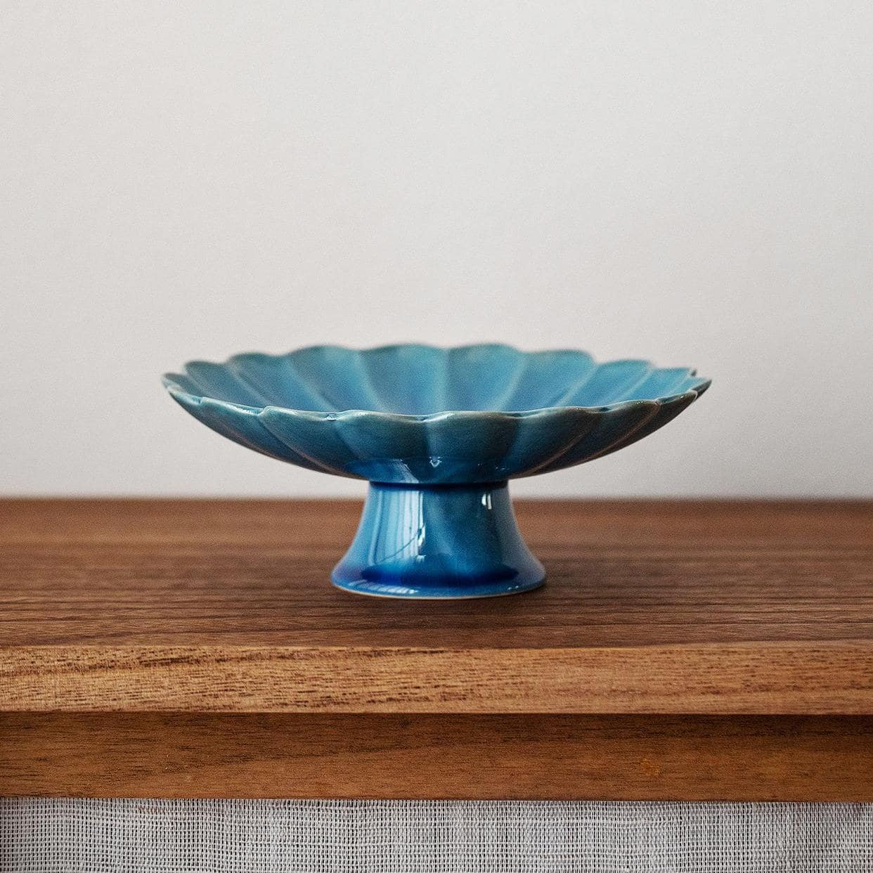 Japanese Mino glazed chrysanthemum-shaped dessert plate with vibrant blue glaze.