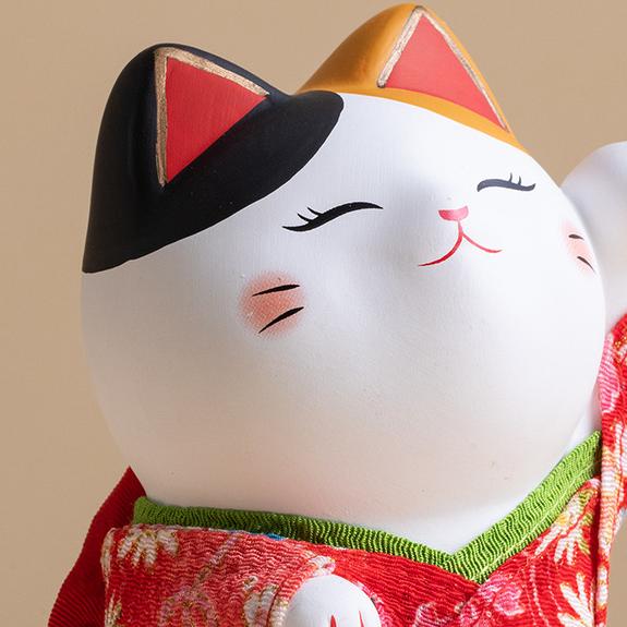 Handcrafted Japanese lucky cat with kimono details for home decor.