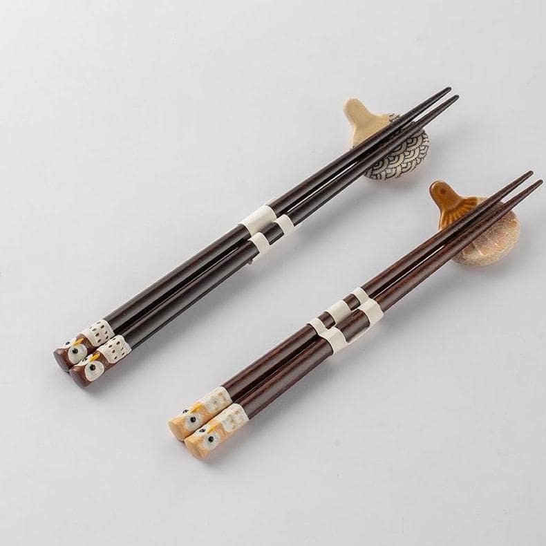 Close-up of handcrafted owl design on wooden chopsticks