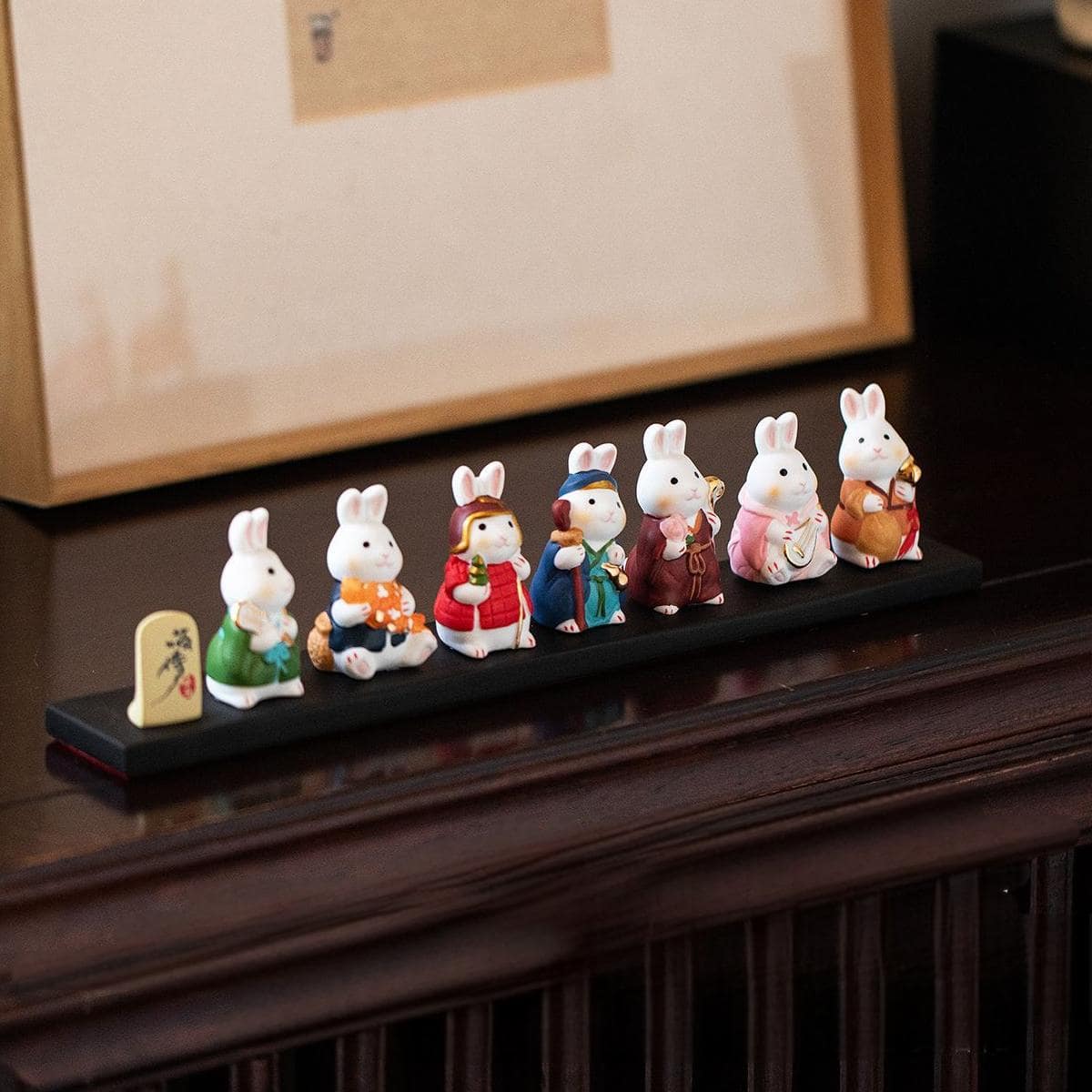 Close-up of red-dressed ceramic lucky cat figurine