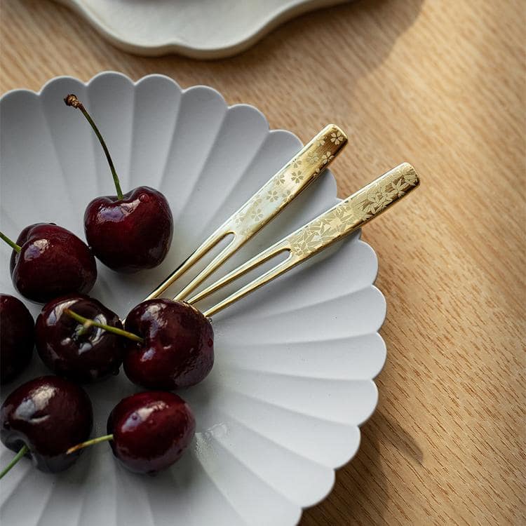 Elegant fork piercing a slice of colorful layered cake