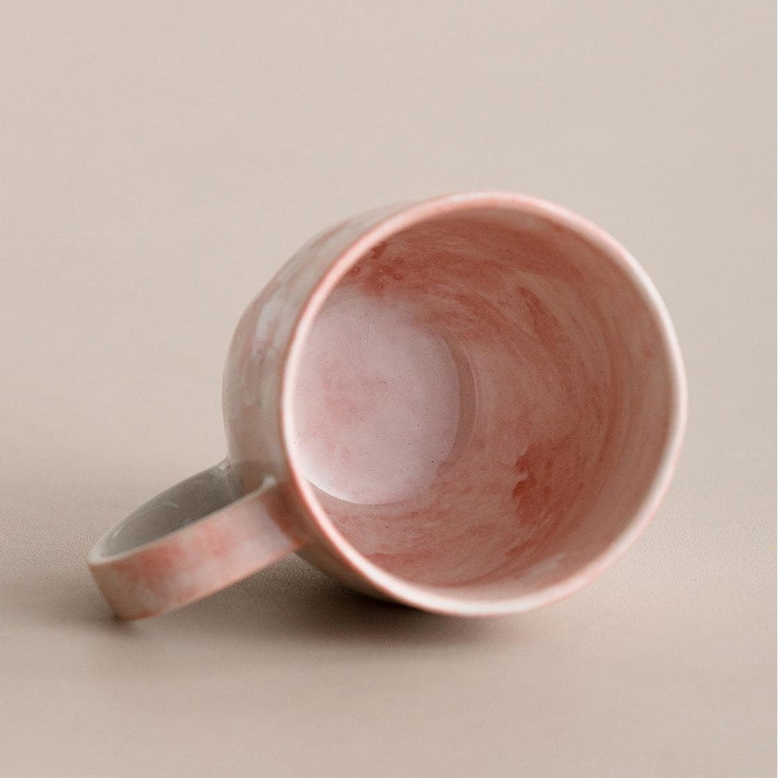 Pair of cherry blossom mugs in pink and blue pastel hues.