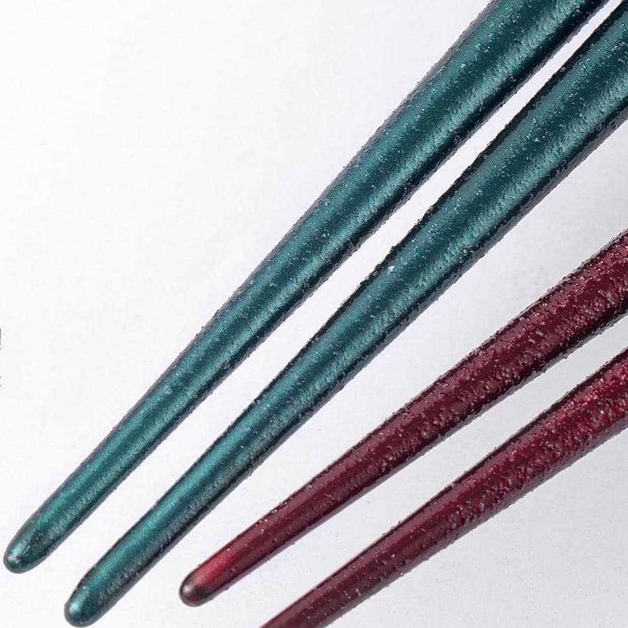 Close-up of non-slip pointed chopsticks in red and blue designs.