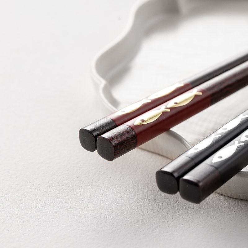 Close-up of artistic fish-patterned wooden chopsticks