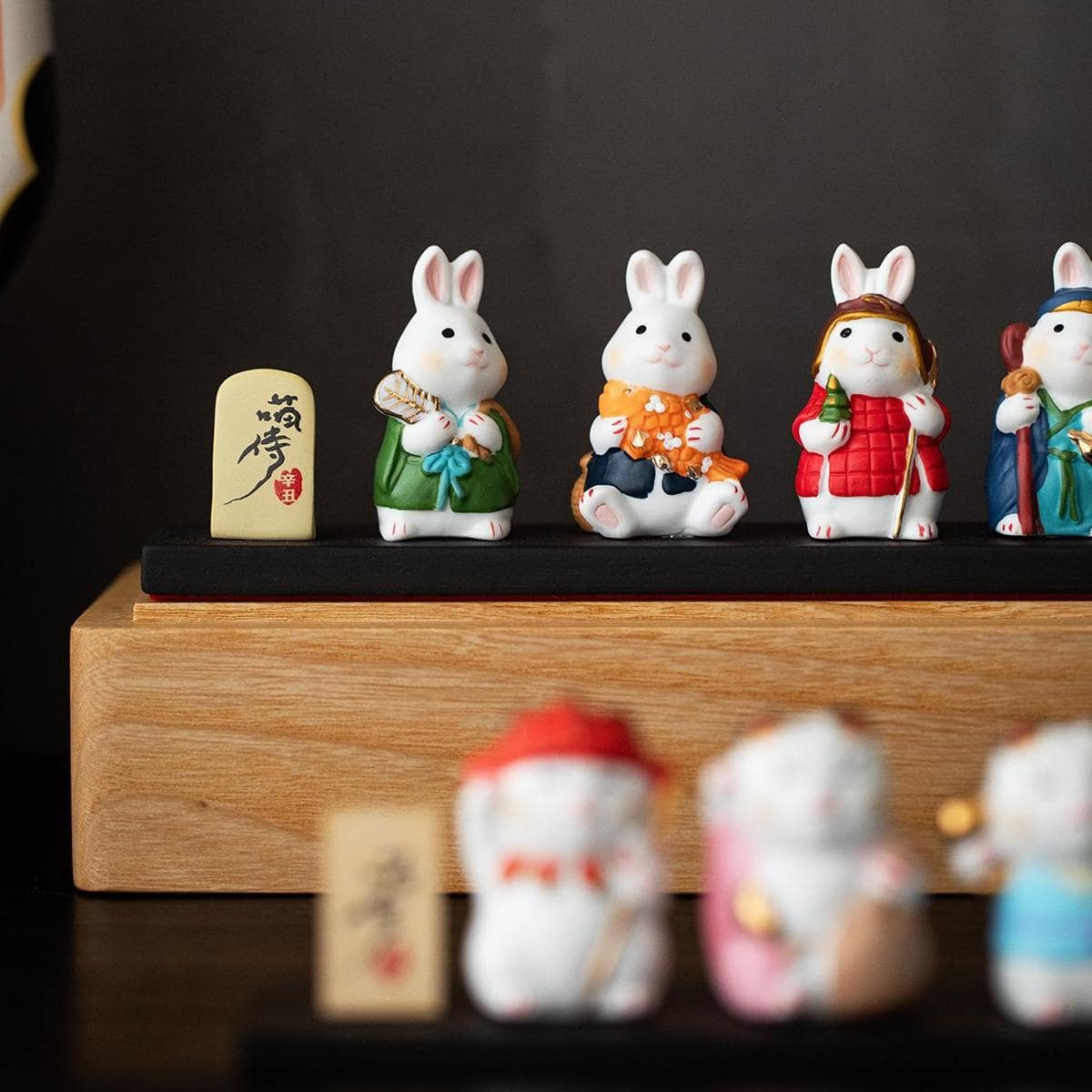 Vibrant lucky cat sculptures in colorful attire