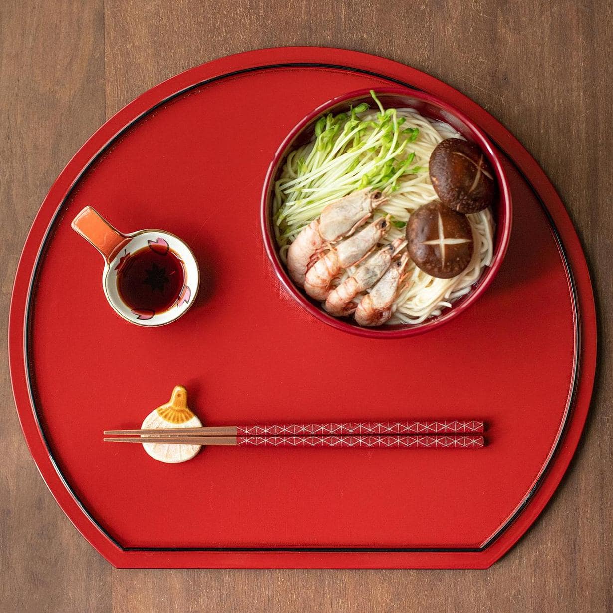 Japanese chopsticks held while dining, showcasing ergonomic design.