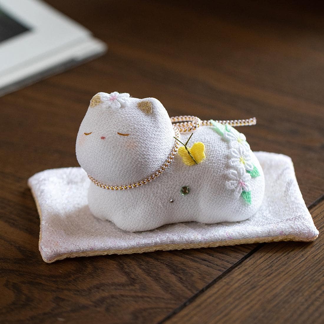 Light-colored lucky cat with angel wings on display