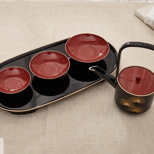 Luxurious Japanese-inspired tea set with crimson tea cups.