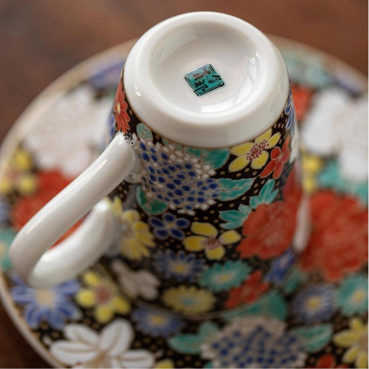 Artistic floral porcelain cup and matching saucer