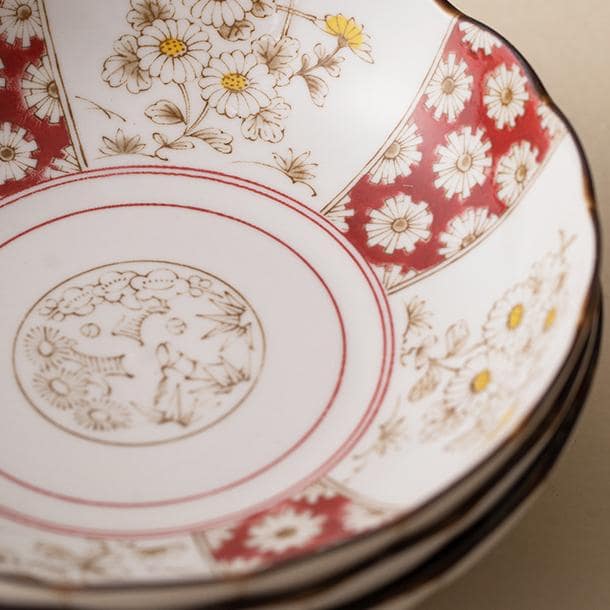 Scalloped edge ceramic plate with Japanese floral details