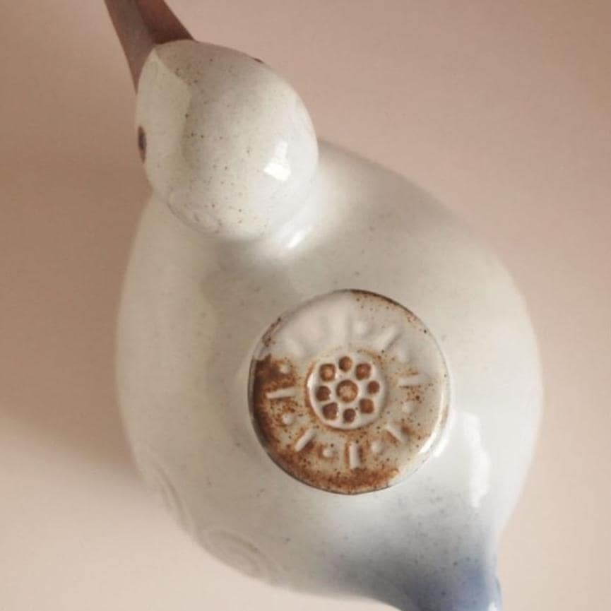 Handmade Japanese bird-shaped ceramic oil pot with swirl patterns.