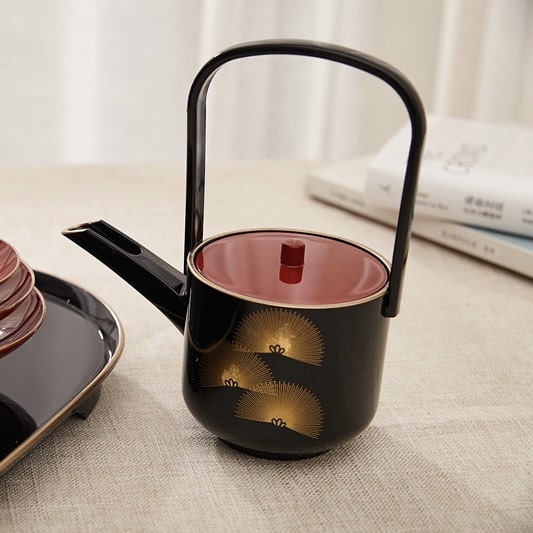 Durable tea cup set with ergonomic teapot handle.