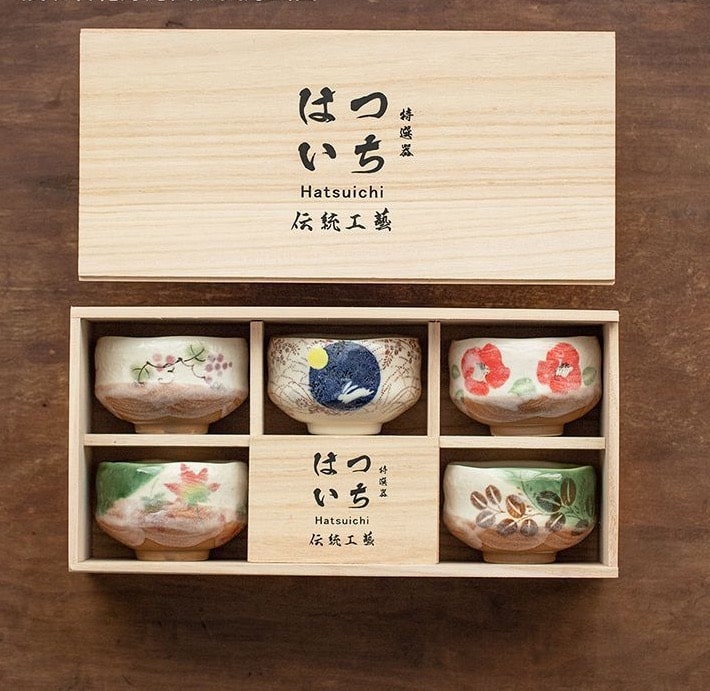 Wooden box tea cup set with six unique hand-painted ceramic cups.