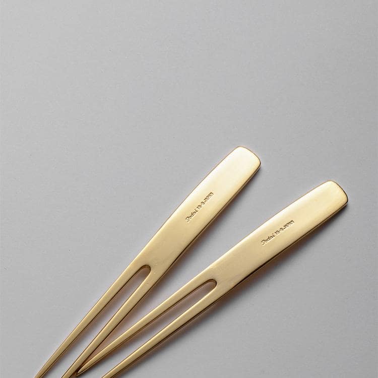 Premium gold dessert fork paired with a modern plate and dessert