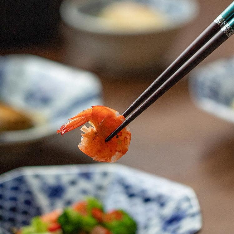 Two pairs of Japanese rabbit-themed solid wood chopsticks on a white background.