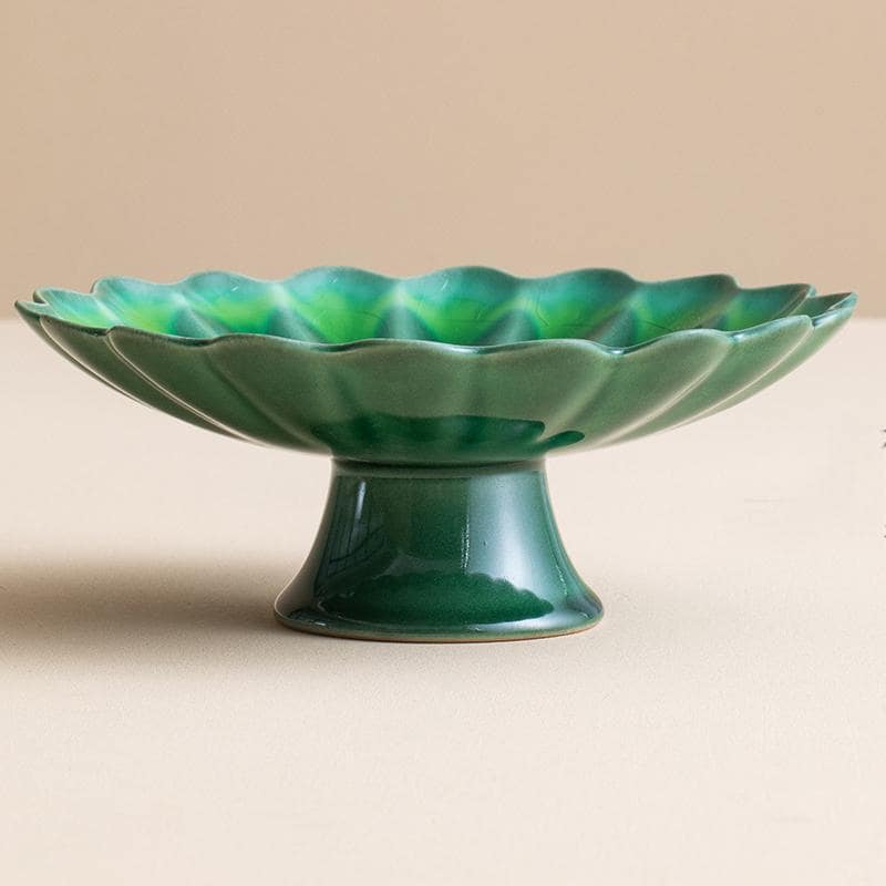 Close-up of chrysanthemum-shaped ceramic fruit plate with crackle glaze.