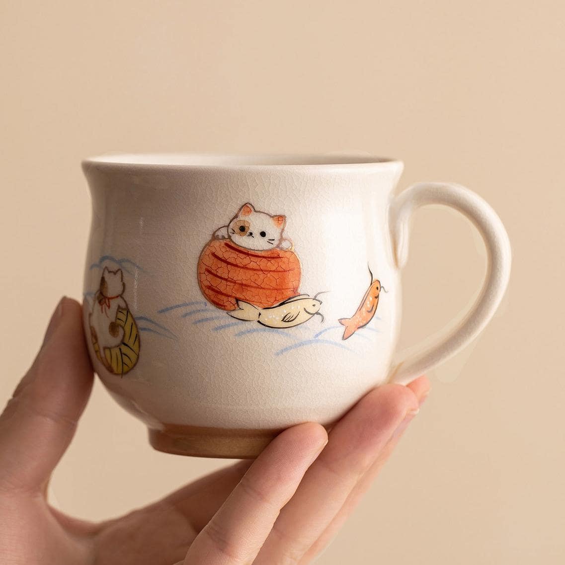 Playful ceramic cup with colorful aquatic animal illustrations.