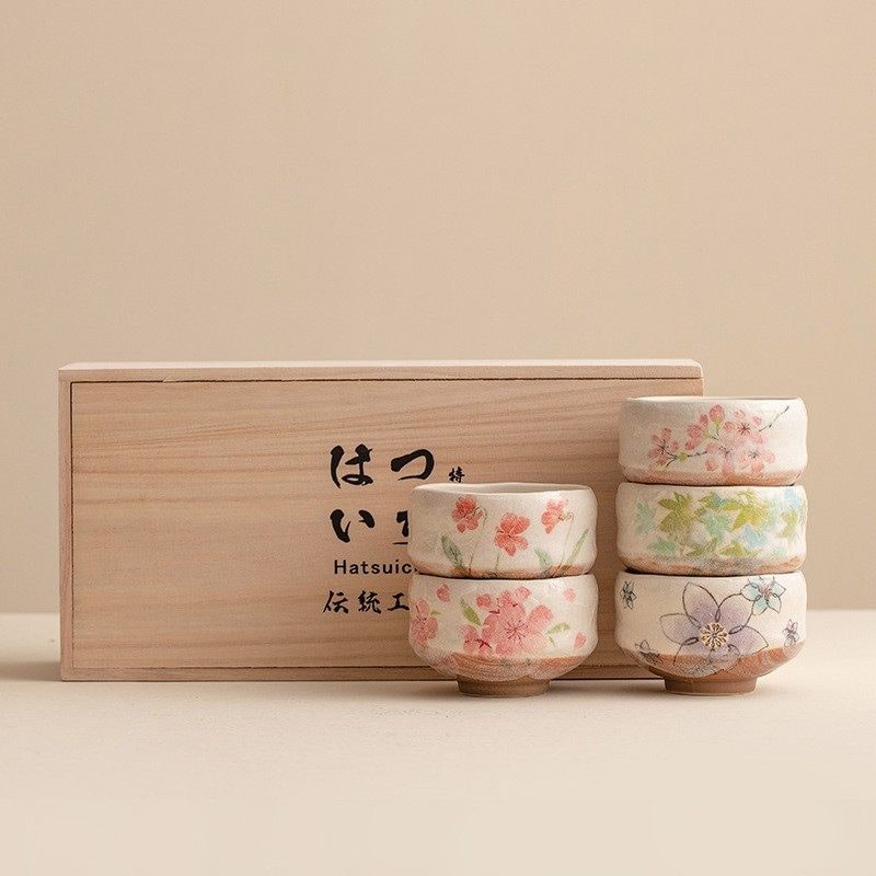 Traditional Japanese tea cup set presented in a luxurious wooden case.