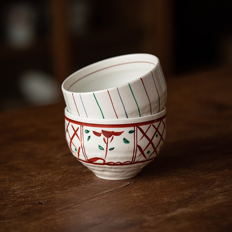 Close-up of red and green hand-painted Japanese bowls