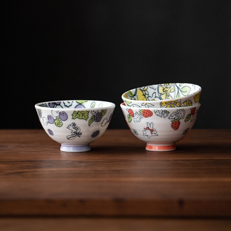 Whimsical Japanese porcelain bowls with fruit and animal motifs