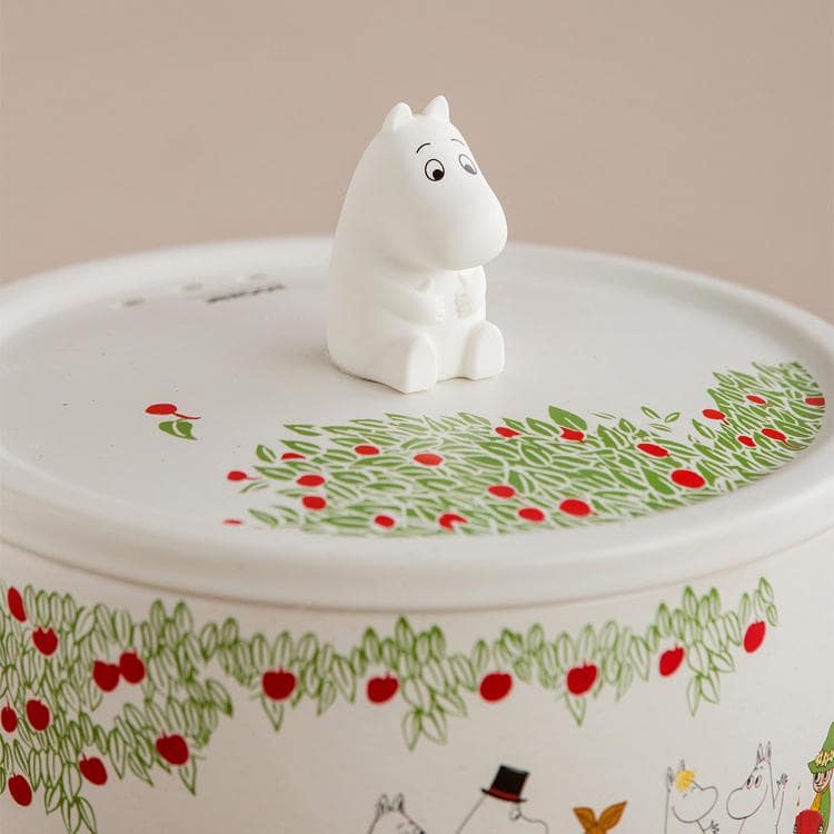 Close-up of Moomin ceramic pot with vibrant yellow lid.