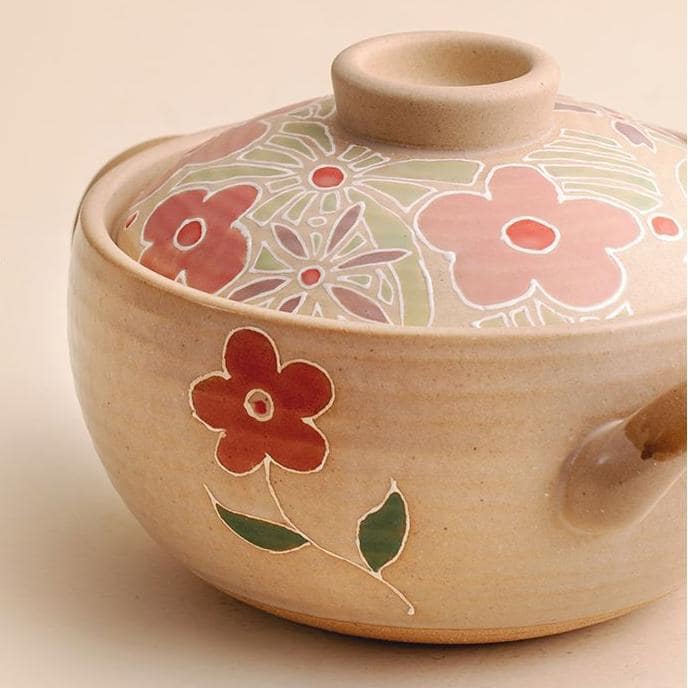 Hand-painted ceramic casserole dishes with floral and whimsical designs