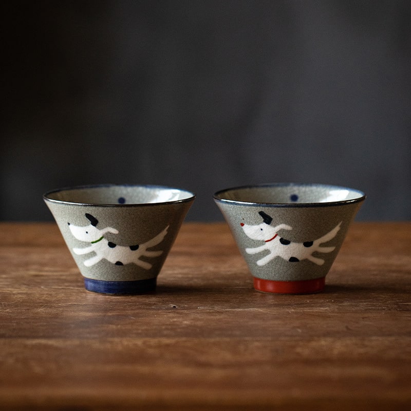 Close-up of crackle-glaze dog-themed ceramic bowls