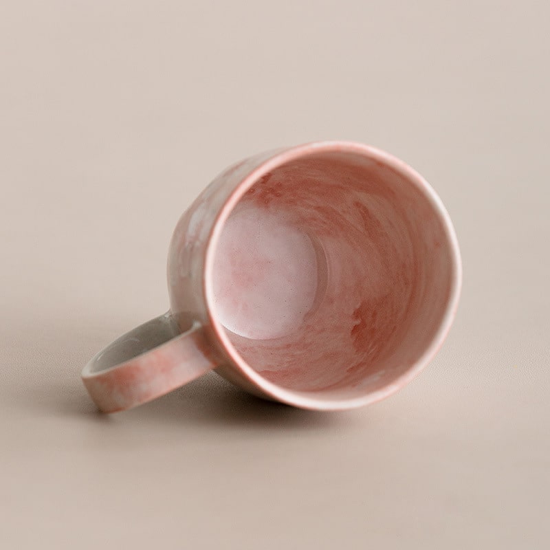 Close-up of the pink cherry blossom ceramic cup interior.