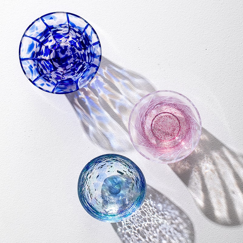 Overhead view of artistic glass cups with colorful patterns