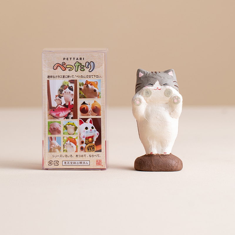 Adorable ceramic cat decoration on a wooden table