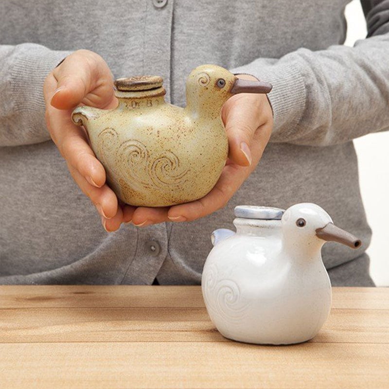 Handmade Japanese bird-shaped ceramic oil pot with swirl patterns.