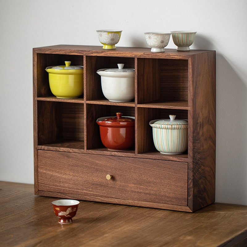 Japanese Kiyomizu-yaki teapot set displayed in a wooden shelf.