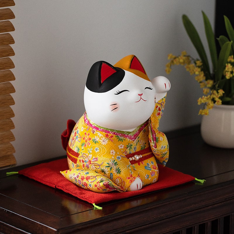 Ceramic lucky cat ornament dressed in a yellow floral kimono