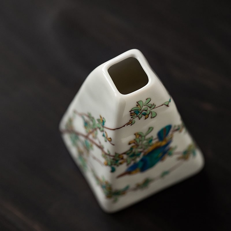 Hand-painted triangular ceramic vase with delicate floral patterns